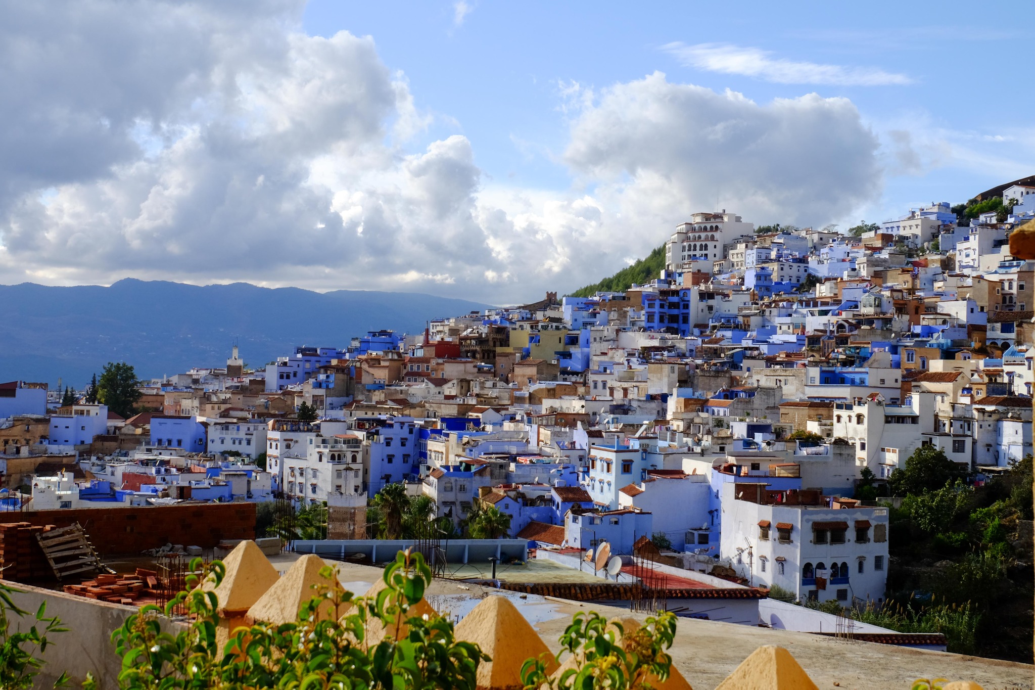 Blue-painted alleyway in Chefchaouen, Morocco at golden hour
