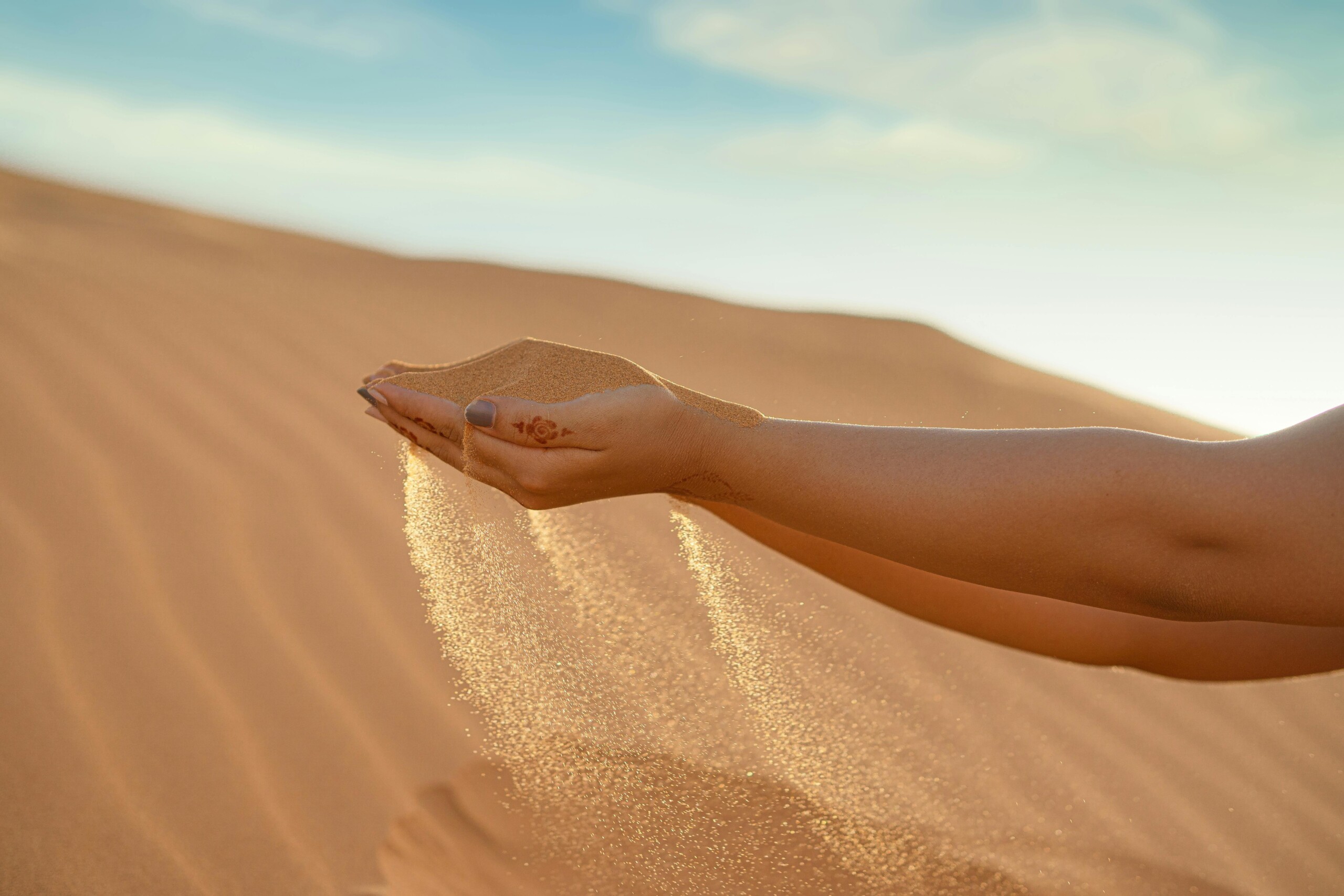 Camel trek across Sahara dunes at sunset, Merzouga, Morocco
