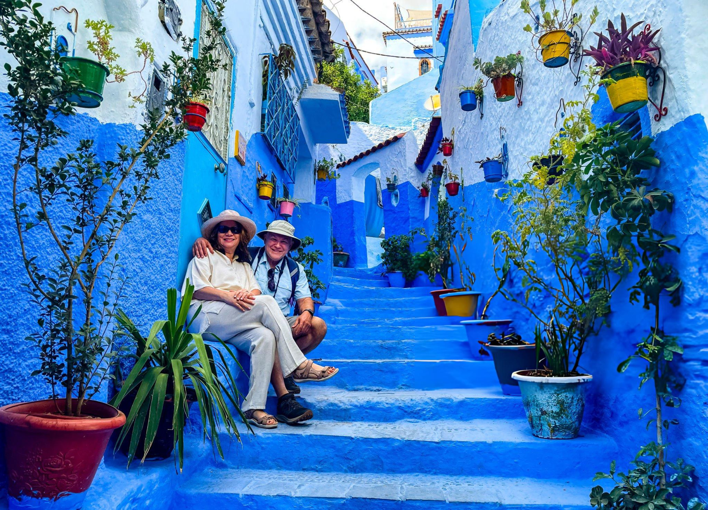 Couple taking picture in the blue city of Chefchaouen, Morocco
